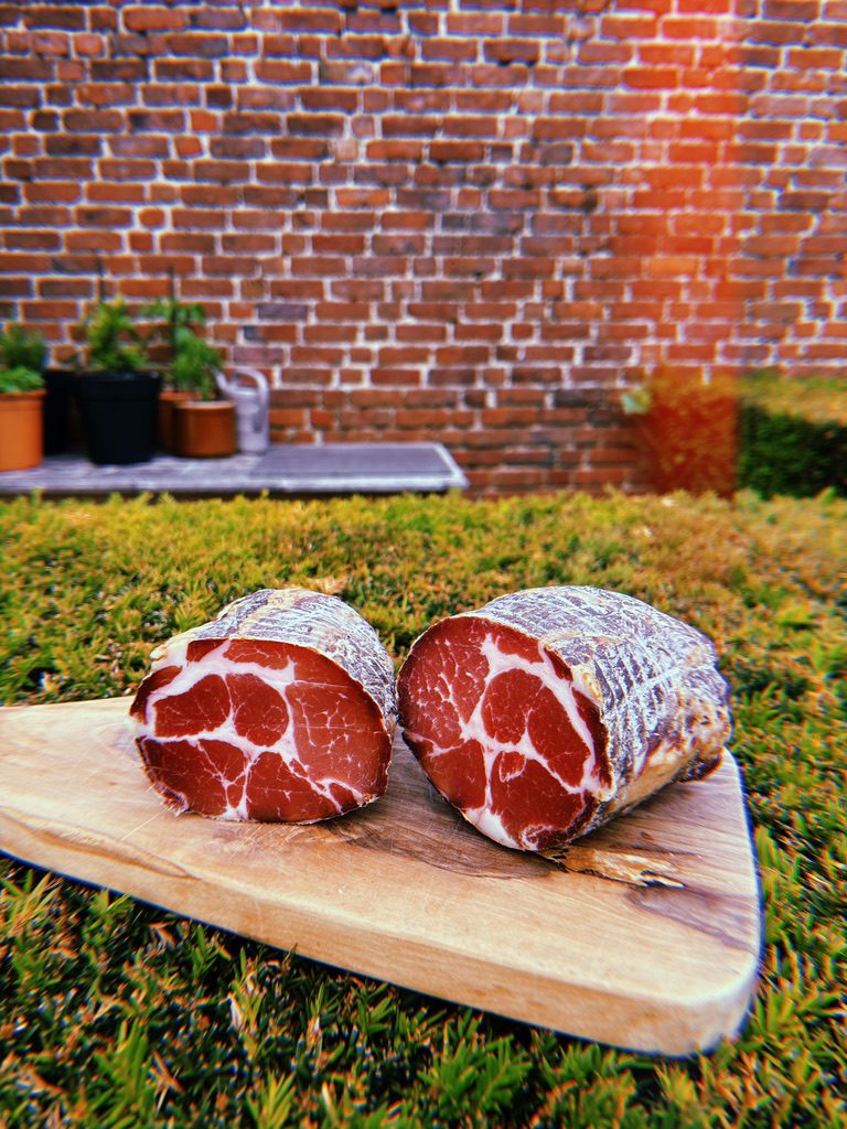 Homemade coppa on a cutting board